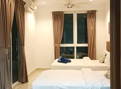 a hotel room with two beds and a window at Gurney Drive Mansion One by RL SUITE in George Town
