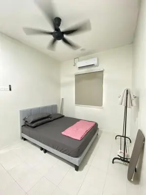 a bedroom with a bed and a ceiling fan at Sofea Homestay Tasek Gelugor in Kampong Kubang Menderong