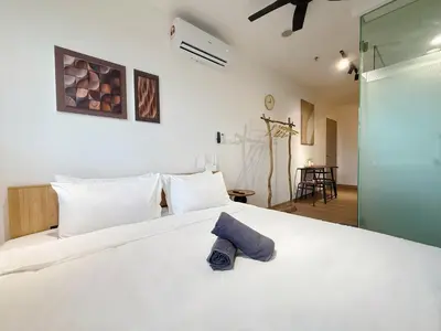 a bedroom with a white bed with a blue towel on it at Cozy Studio I Riveria City I 1km to KL Sentral in Gua Sai