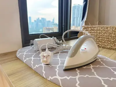 a bed with a phone on top of it at Cozy Studio I Riveria City I 1km to KL Sentral in Gua Sai