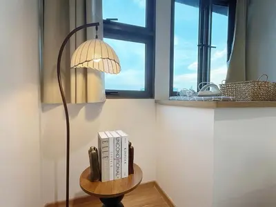 a table with books and a lamp on it at Cozy Studio I Riveria City I 1km to KL Sentral in Gua Sai