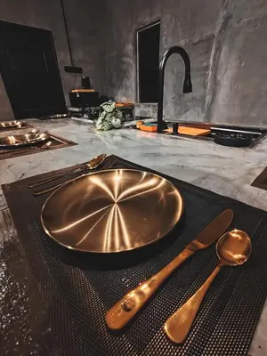 a copper plate and spoon on a table with a sink at Afqa Nest Industrial Charm in Gua Sai