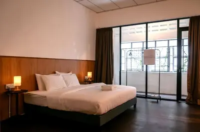 a bedroom with a large bed and a large window at Aayu Chowrasta - 3 mins walk to Penang Road Chendul in George Town