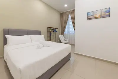 a bedroom with a white bed and a chair at 7 \u53f7 Kota Cozy Homestay 3 storey 22pax-7 Room-SingK in Gua Sai