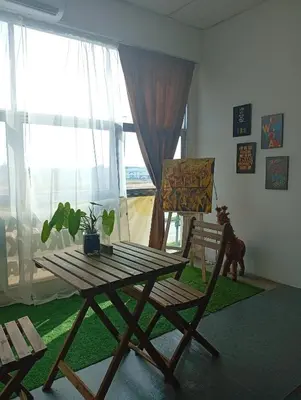 a picnic table and a chair in a room with a window at Bajet Homestay - Teratak Singgah in Seri Iskandar