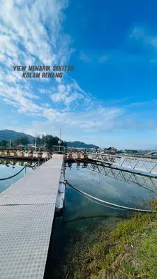 a dock with a boat in the water at Marina 2 HOMESTAY JETI LUMUT MANJUNG in Lumut