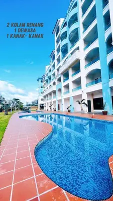 a swimming pool in front of a building at Marina 2 HOMESTAY JETI LUMUT MANJUNG in Lumut