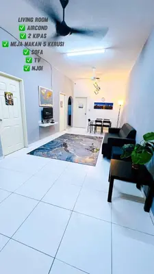a living room with a couch and a table at APPARTMENT Samudera Manjung Point in Seri Manjung