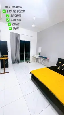 a bedroom with a yellow bed in a white room at APPARTMENT Samudera Manjung Point in Seri Manjung