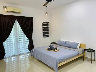 a bedroom with a bed with blue pillows and a window at BBF Cozy Hub in Kamunting