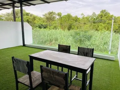 a table and chairs on a patio with a window at BBF Cozy Hub in Kamunting