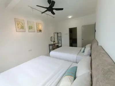 a bedroom with two beds and a ceiling fan at Dream 7 at Emerald avenue in Brinchang
