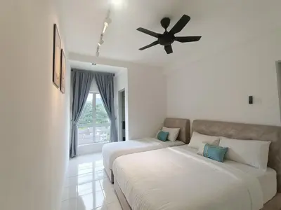 a bedroom with two beds and a ceiling fan at Dream 7 at Emerald avenue in Brinchang