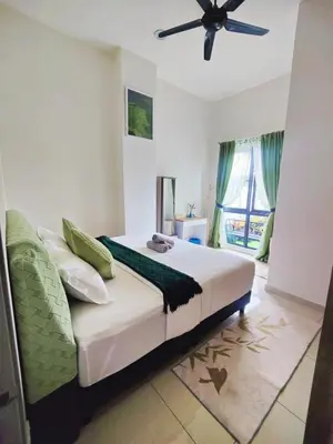 a bedroom with a bed and a ceiling fan at #MyMidoriGetaway , CameronFair, Cameron Highlands in Tanah Rata