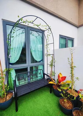 a bench in front of a window with plants at #MyMidoriGetaway , CameronFair, Cameron Highlands in Tanah Rata