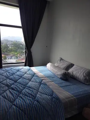 a bedroom with a bed with a large window at Oasis Condominiums Ipoh in Ipoh
