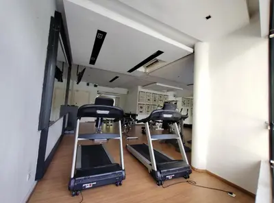 a gym with two treadmills and a mirror at Oasis Condominiums Ipoh in Ipoh