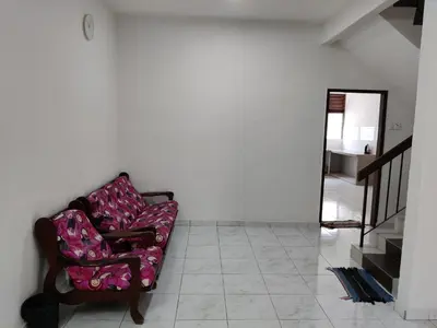 a living room with a couch and a staircase at CLP perai homestay near Sri Muniswarar temple in Perai