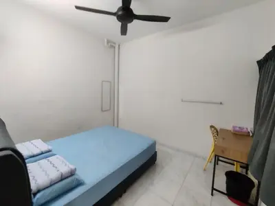 a bedroom with a blue bed and a ceiling fan at CLP perai homestay near Sri Muniswarar temple in Perai