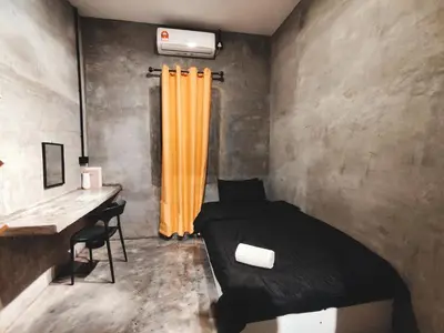 a bedroom with a bed and a desk with a desk at Afqa Nest Industrial Charm in Gua Sai