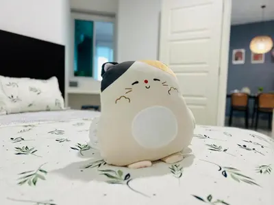 a hello kitty toy is sitting on a bed at Mansion One l 7pax 2R1B l Seaview l Gleneagles l by PerfectSweetHome in George Town