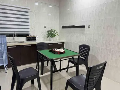 a kitchen with a table and chairs and a sink at 25 pax Golf Resort Private Villa in Kulim