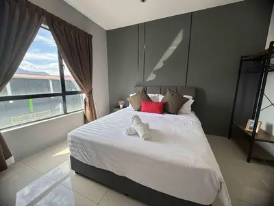 a bedroom with a white bed with a large window at Manhattan Ipoh Family Suites By Inn Lux in Ipoh