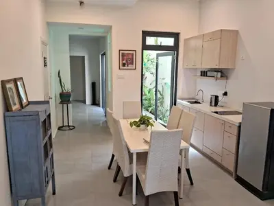 a kitchen and dining room with a table and chairs at Georgetown vintage garden 5pax 2BR Homestay in George Town