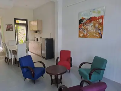 a room with chairs and a table and a kitchen at Georgetown vintage garden 5pax 2BR Homestay in George Town