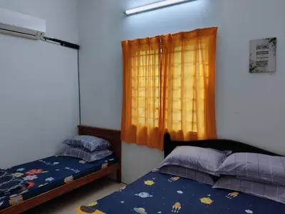 a bedroom with two beds and a window at Luna Homestay Lumut in Lumut