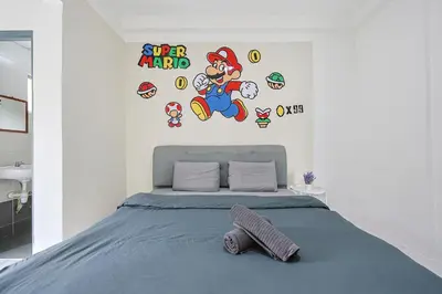 a bedroom with a bed with sonic the hedgehog wall decals at Mario Inspired Highlands Escape Family Homestay Brinchang - Clover Home 5-20 in Brinchang