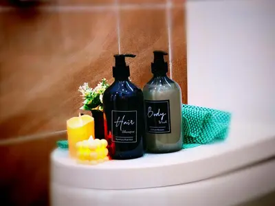 two bottles of soap and a candle on a shelf at Ipoh Happy Home Boutique Villa by City Home Empire in Ipoh