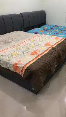 a bed with a comforter with flowers on it at KKB Gathering Home - Private Room in Shared House in Kuala Kubu Baharu