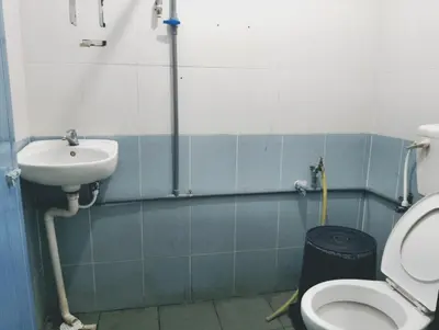 a bathroom with a sink and a toilet at Dales Guest House in Perai