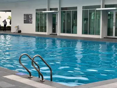 a swimming pool with a metal railing in a building at Stay at Anderson Condo1615 Ipoh Town in Ipoh