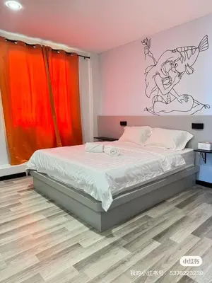 a bedroom with a bed with a cartoon on the wall at \u5343\u5c9b\u7f8e\u4eba\u9c7c\u9152\u5e97 in Gua Sai