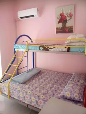 two bunk beds in a room with a bed at Batu Kawan HS in Simpang Ampat