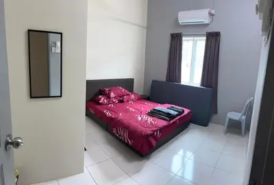 a bedroom with a bed with a red comforter and a window at RB Homestay Modern Comfort in Hutan Melintang
