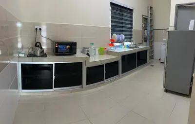 a kitchen with a counter with a tv on it at RB Homestay Modern Comfort in Hutan Melintang