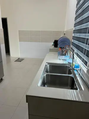 a kitchen sink with a dish drying rack next to it at RB Homestay Modern Comfort in Hutan Melintang