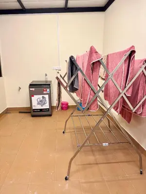 a chair in a room with a machine in the background at Heartstay Tanjong Karang \u598d\u83c1\u540d\u5bbf in Kampong Tanjong Karang