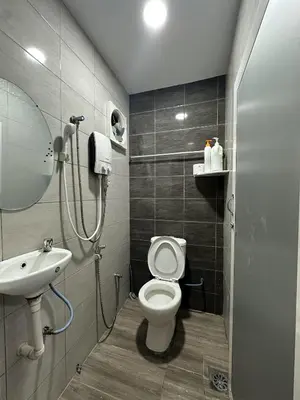 a bathroom with a toilet and a sink at Specious Living Cozy House in Bukit Mertajam