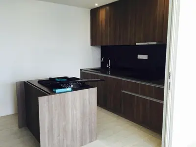 a small kitchen with a stove and a microwave at By the Sea PENTHOUSE duplex in Batu Ferringhi