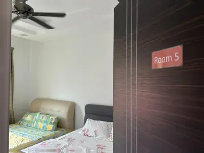 a bedroom with a bed with a room sign on the door at Seri Hayzar Homestay in Gua Sai