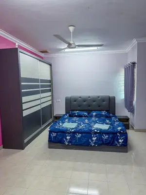 a bedroom with a bed and a ceiling fan at M S Villa Homestay Ayer Tawar in Ayer Tawar