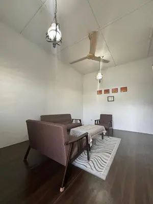 a living room with a couch and a table at Rumah Bonda in Gua Sai