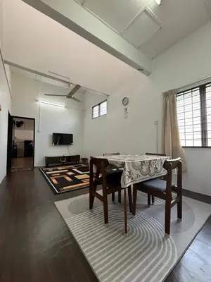 a living room with a table and a rug at Rumah Bonda in Gua Sai