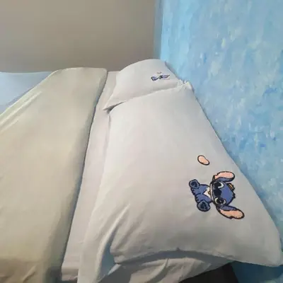 a white pillow with a teddy bear on it at Love Mickey Cameron Highlands in Cameron Highlands