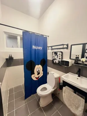 a bathroom with a mickey shower curtain with a toilet at Love Mickey Cameron Highlands in Cameron Highlands