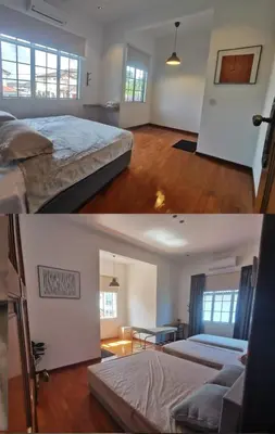 a bedroom with two beds and a living room at Ryui's Quiet Bungalow - Room Only - No Extra Tax in Sungai Petani